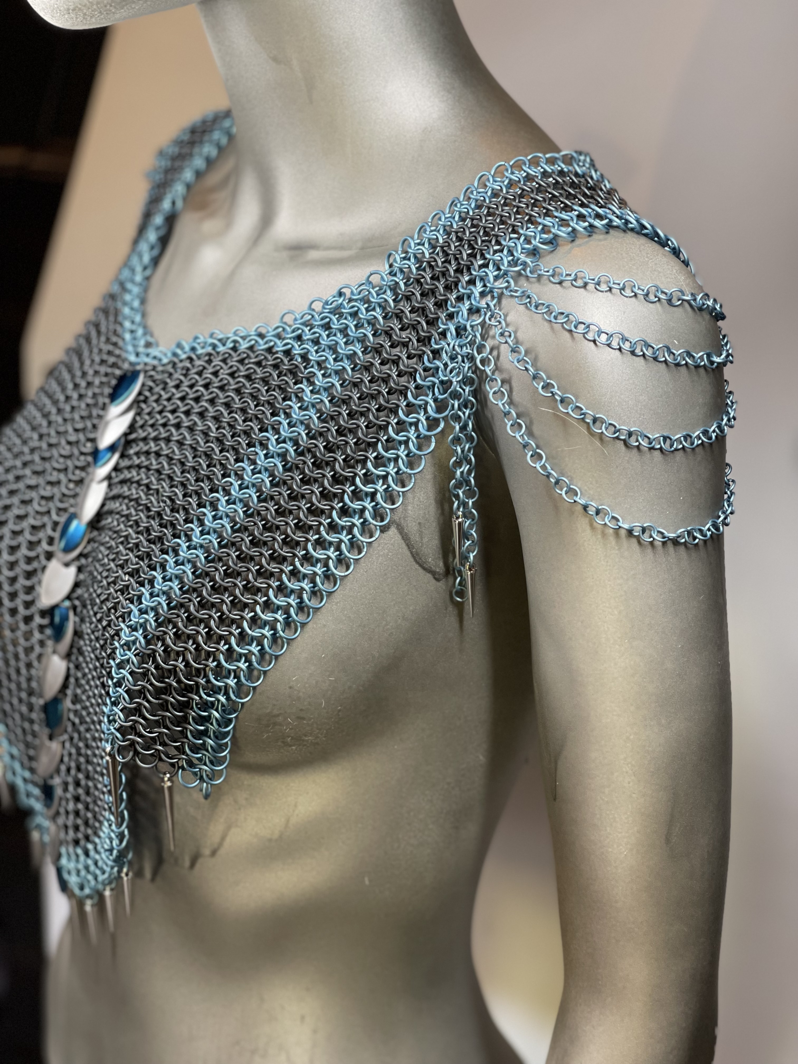 “European 4-in-1 chainmaille necklace in grey with light blue accents and silver and blue dragon scale shoulders, named Winterborne—handcrafted for icy fantasy elegance.”
